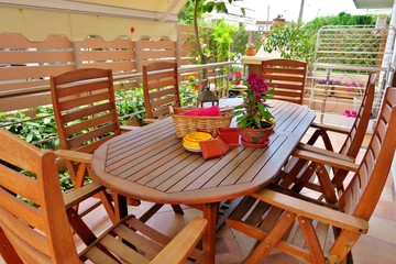 beautiful outdoor area with wooden table and chairs