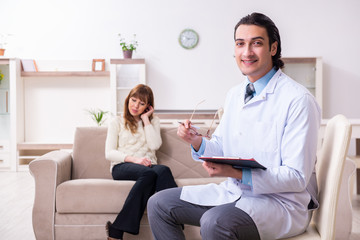 Young female patient discussing with male psychologist personal 