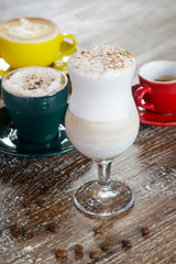 A cup of hot fresh coffee with rich foam on the wooden table