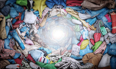 Sale concept. Top view to vortex of clothes. Donation.