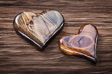 two glossy wooden heart on vintage wood