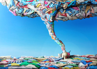 Clothes in the form of a tornado on a sky background. Clothing concept.