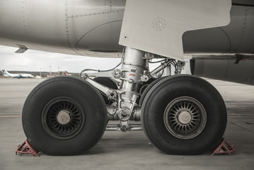 Close-up of the chassis of the passenger aircraft. The plane in the airport terminal. Airbus a 330. - obrazy, fototapety, plakaty