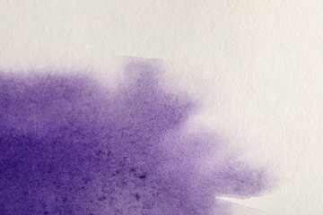 purple colorful watercolor paint spill on white textured background with copy space