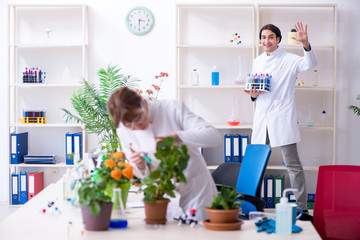Two young botanist working in the lab 