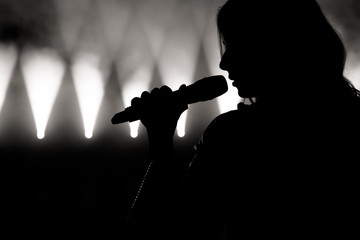 Singer in silhouette. Close up image of live singer on stage