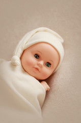 Baby doll toy photodraphed in a newborn style.