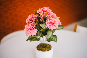 Coloeful artificial flowers in a pot decorate in a room, Color Effect.