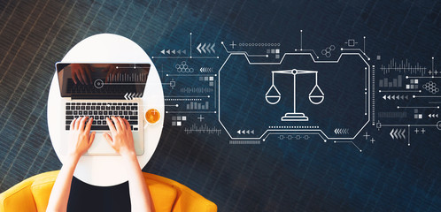 Justice theme with person using a laptop on a white table