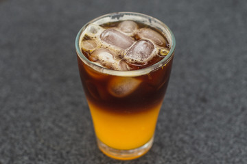 Close up black orange coffee, top view, cold coffee cocktail recipe idea. Selective focus