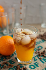 Close up black orange coffee, cold coffee cocktail recipe idea. Selective focus