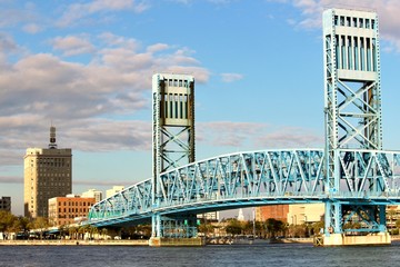 Jacksonville Bridge on a bright sunshine day with blue sky and puffy white clouds.