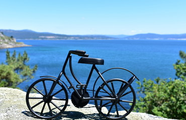 Coast with black iron bicycle. Galicia, Spain.
