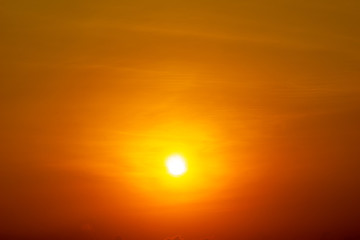 The yellow sun shining on orange sky nature background