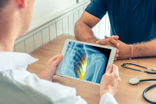 Doctor holding a digital tablet with x-ray of the chest of the patient with pain on the ribs