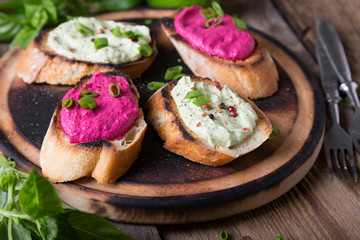 Various bruschettas with avocado and beetroot