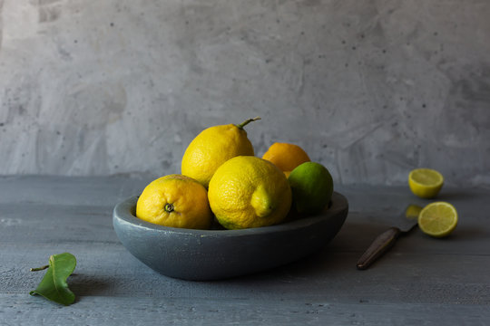 Still life with fresh yellow lemons in a bowl