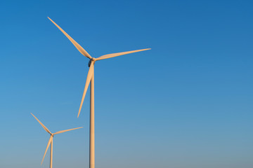 Modern wind turbines generating clean power and a blue sky. Groningen, Holland.