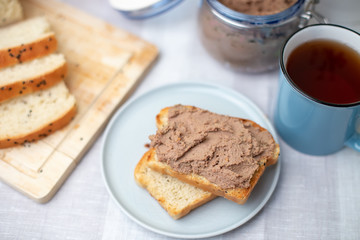 Fototapeta na wymiar Homemade chicken liver pate, homemade white bread. Breakfast. Selective focus, close-up.