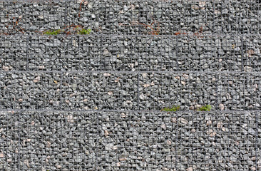Grey ground stone rubble background of many small stones