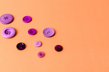 Purple buttons over salmon orange background with copy space 