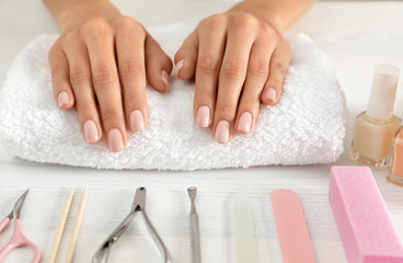 Obraz na płótnie Canvas Woman waiting for manicure and tools on table, closeup. Spa treatment