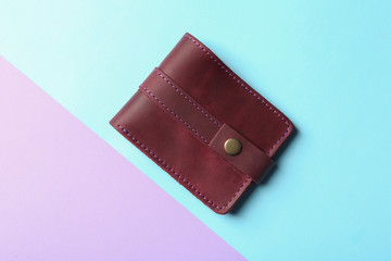 Stylish wallet on color background, top view