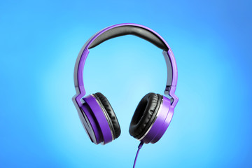 Fototapeta na wymiar Stylish headphones with pads on color background