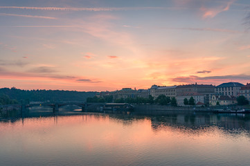 Beautiful sunrise over Vltava river with Prague cityscape