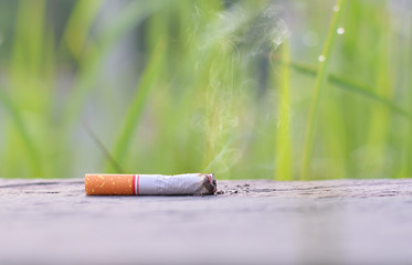 Stop smoking,cigarette on wood table top with smoke no people