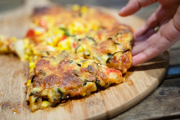 Custom made pizzas at home on appetizing brown wooden trays