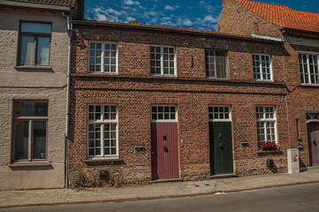 Brick facade of old house and a blue sky in Bruges
