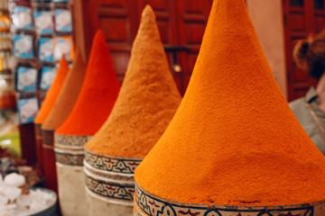 Bright multicolored red and orange spices in oriental bazaar