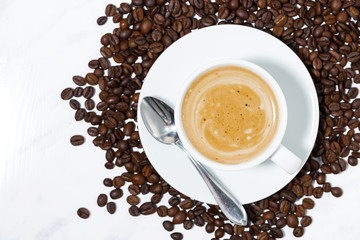 espresso cup on coffee beans, conceptual photography, top view