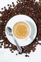 espresso cup on coffee beans, conceptual photography, vertical top view