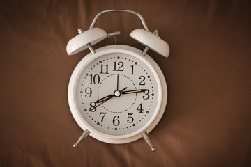 Alarm clock on the bed,  Wakes up in the morning , Vintage