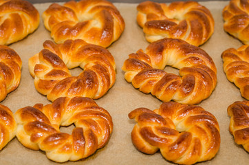 Homemade baked sweet rolls on an oven tray