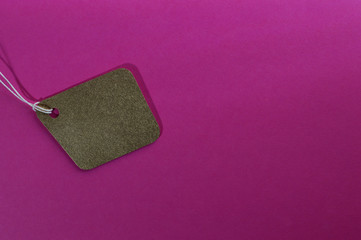 gold irregular paper tag on pink background