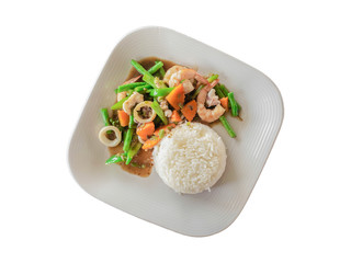 Stir fried mixed vegetables with shrimp,squid and Yard long bean, carrots topped with oyster sauce on dish, isolated white background