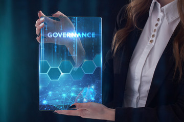 The concept of business, technology, the Internet and the network. A young entrepreneur working on a virtual screen of the future and sees the inscription: Governance