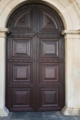 The architectural element is an arched entrance door with a graphic ornament in a stone frame. Concept: the influence of Arabic style on Portuguese architecture.