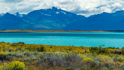 Naklejka na ściany i meble Deep Greenish Blue Lake surrounded by mountain in Argentina