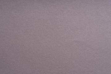 Paper background gray color. Rough paper texture. Closeup. Macro.