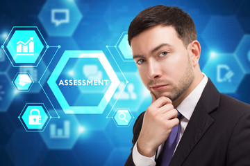 The concept of business, technology, the Internet and the network. A young entrepreneur working on a virtual screen of the future and sees the inscription: Assessment