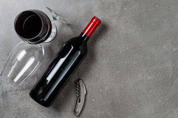 Bottle of wine glasses and opener on concrete background. Copy Space.