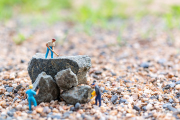 Miniature people : worker team working on the rock , Team work  concept