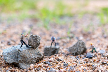 Miniature people : worker team working on the rock , Team work  concept