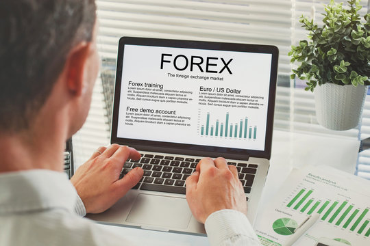 Forex concept on the screen of computer, business man reading about trading