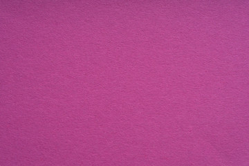 Fototapeta premium Paper background purple color. Rough paper texture. Closeup. Macro.