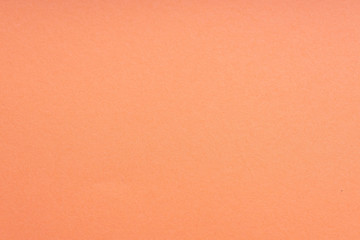 Fototapeta premium Paper background coral color. Rough paper texture. Closeup. Macro.